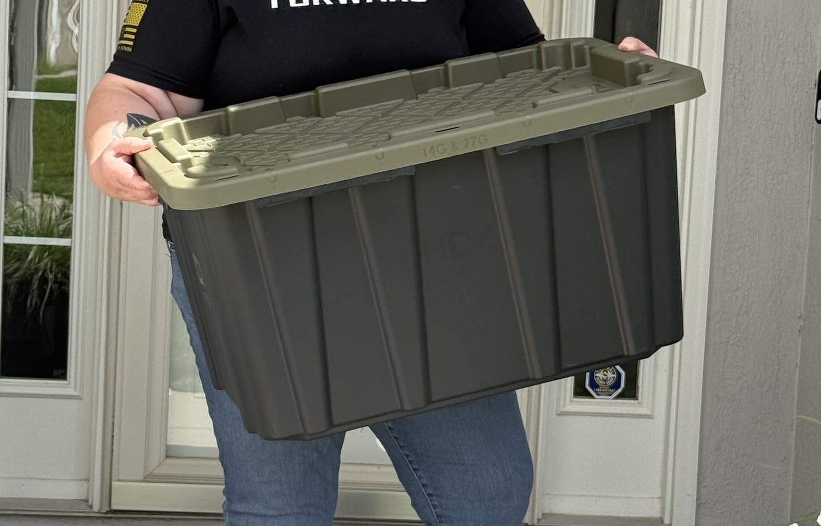 Close-up of one of our totes: black base, green snap-on lid, molded handles