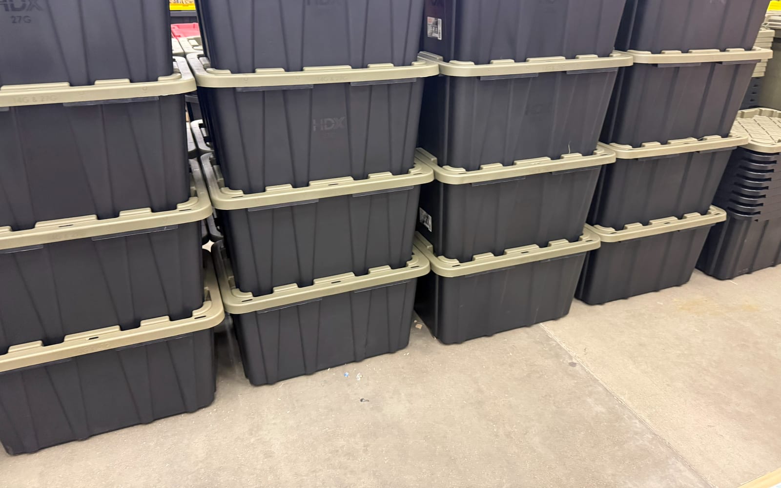 Rows of our black totes with green lids stacked and ready to go
